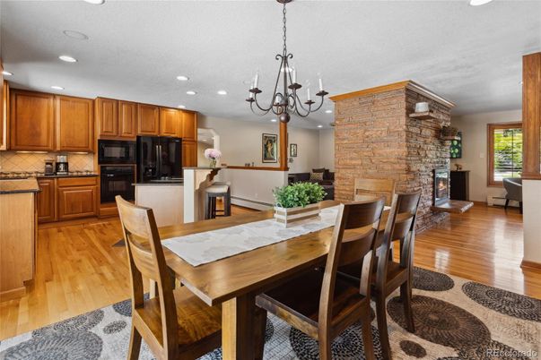 Chandelier, Dining room, Fireplace, Interior, Kitchen, Recessed Lighting, Stone Walls, Wood Texture Flooring