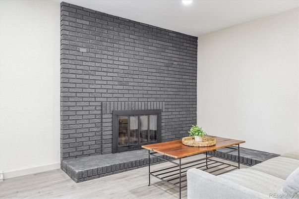 Fireplace, Interior, Living room, Recessed Lighting, Stone Walls, Wood Texture Flooring