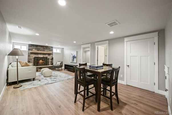 Dining room, Fireplace, Interior, Living room, Recessed Lighting, Stone Walls, Wood Texture Flooring
