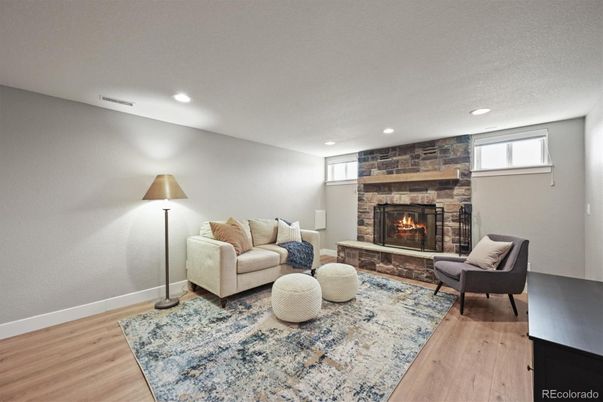 Fireplace, Interior, Living room, Recessed Lighting, Stone Walls, Wood Texture Flooring