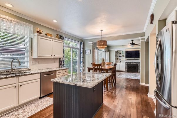 Chandelier, Dining room, Fireplace, Interior, Kitchen, Pendant Lights, Recessed Lighting, Stainless Steel Appliances, Wood Texture Flooring