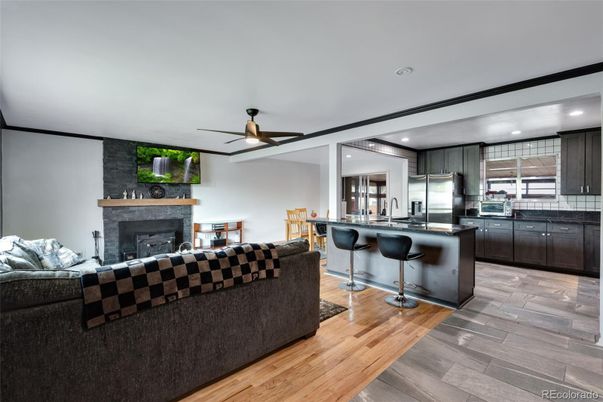 Fireplace, Interior, Kitchen, Living room, Recessed Lighting, Stainless Steel Appliances, Stone Walls, Wood Texture Flooring