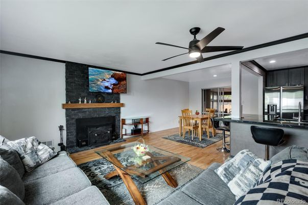 Dining room, Fireplace, Interior, Kitchen, Living room, Recessed Lighting, Stainless Steel Appliances, Stone Walls, Wood Texture Flooring