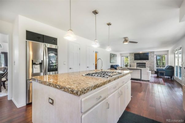 Fireplace, Interior, Kitchen, Living room, Pendant Lights, Stainless Steel Appliances, Wood Texture Flooring
