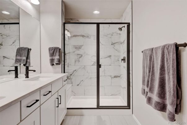 Bathroom, Dual Sink Vanities, Glass Shower, Interior, Marble Walls, Recessed Lighting