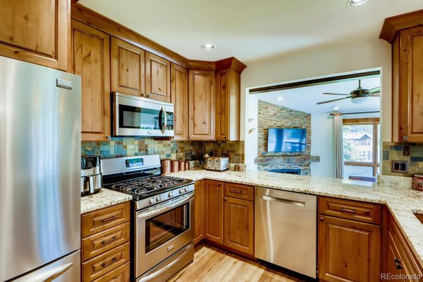 Interior, Kitchen, Recessed Lighting, Stainless Steel Appliances, Stone Walls, Wood Texture Flooring
