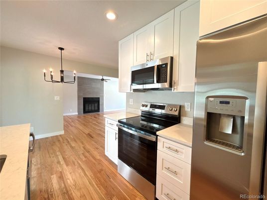 Chandelier, Fireplace, Interior, Kitchen, Pendant Lights, Recessed Lighting, Wood Texture Flooring