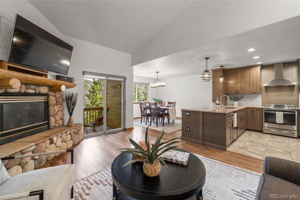 Dining room, Fireplace, Interior, Kitchen, Pendant Lights, Recessed Lighting, Stainless Steel Appliances, Wood Texture Flooring