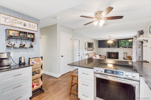 Fireplace, Interior, Kitchen, Stainless Steel Appliances, Stone Walls, Wood Texture Flooring