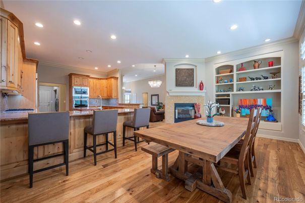 Chandelier, Dining room, Fireplace, Interior, Kitchen, Recessed Lighting, Stainless Steel Appliances, Wood Texture Flooring