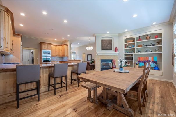 Chandelier, Dining room, Fireplace, Interior, Kitchen, Recessed Lighting, Stainless Steel Appliances, Wood Texture Flooring