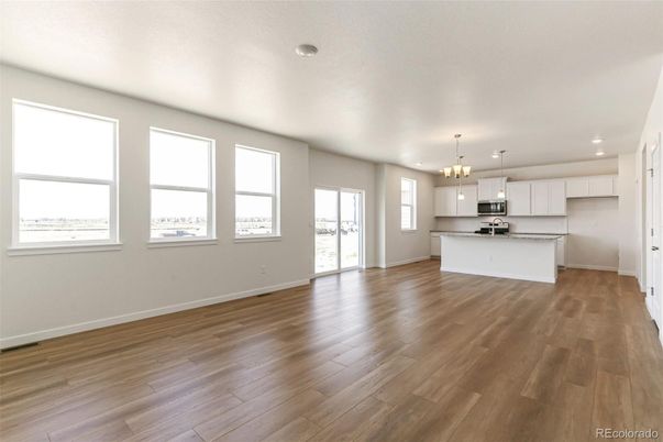 Empty room, Interior, Kitchen, Pendant Lights, Recessed Lighting, Stainless Steel Appliances, Wood Texture Flooring