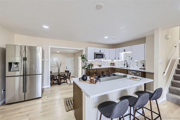 Dining room, Interior, Kitchen, Marble Walls, Recessed Lighting, Stainless Steel Appliances, Wood Texture Flooring
