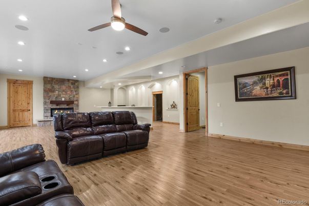 Fireplace, Interior, Living room, Recessed Lighting, Stone Walls, Wood Texture Flooring