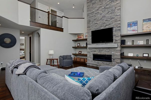 Fireplace, Interior, Living room, Recessed Lighting, Stone Walls, Wood Texture Flooring