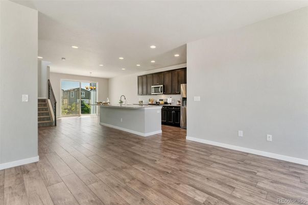 Empty room, Interior, Kitchen, Pendant Lights, Recessed Lighting, Stainless Steel Appliances, Wood Texture Flooring