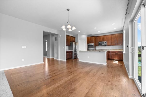 Chandelier, Empty room, Interior, Kitchen, Pendant Lights, Recessed Lighting, Stainless Steel Appliances, Wood Texture Flooring