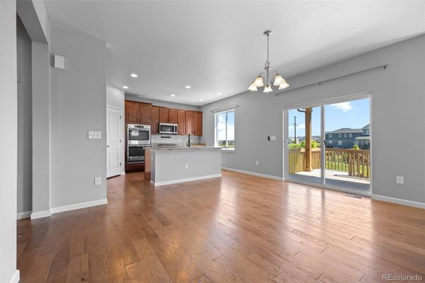Chandelier, Empty room, Interior, Kitchen, Recessed Lighting, Stainless Steel Appliances, Wood Texture Flooring