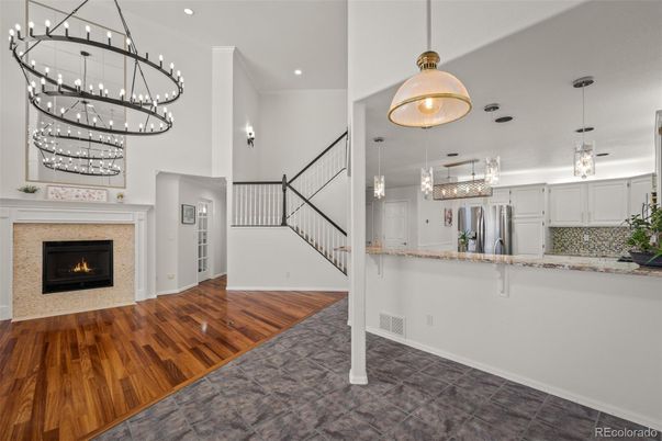 Chandelier, Fireplace, Interior, Kitchen, Pendant Lights, Recessed Lighting, Stainless Steel Appliances, Wood Texture Flooring