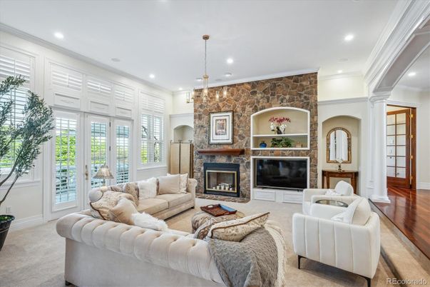 Chandelier, Fireplace, Interior, Living room, Recessed Lighting, Stone Walls, Wood Texture Flooring