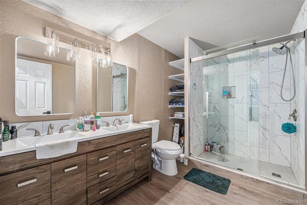 Bathroom, Dual Sink Vanities, Glass Shower, Interior, Marble Walls, Wood Texture Flooring
