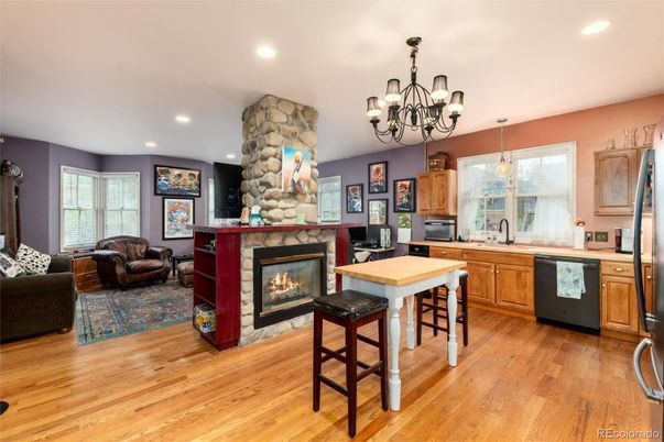 Chandelier, Fireplace, Interior, Kitchen, Living room, Pendant Lights, Recessed Lighting, Stone Walls, Wood Texture Flooring