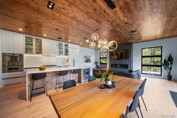 Dining room, Fireplace, Interior, Kitchen, Pendant Lights, Recessed Lighting, Stainless Steel Appliances, Stone Walls, Wooden Ceilings, Wood Texture Flooring
