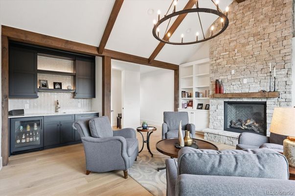 Chandelier, Fireplace, Interior, Living room, Pendant Lights, Stone Walls, Wooden Beams, Wood Texture Flooring