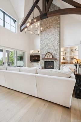 Chandelier, Fireplace, Interior, Living room, Pendant Lights, Stone Walls, Wooden Beams, Wood Texture Flooring