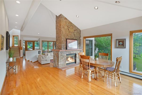 Dining room, Fireplace, Interior, Living room, Recessed Lighting, Stone Walls, Wood Texture Flooring