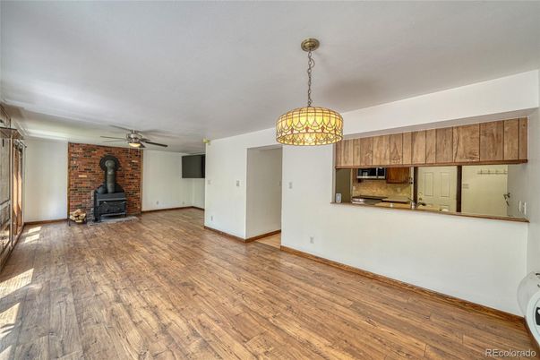 Empty room, Fireplace, Interior, Kitchen, Pendant Lights, Stone Walls, Wood Texture Flooring