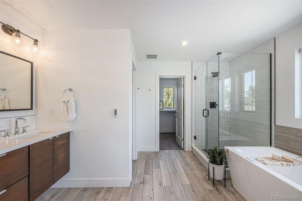 Bathroom, Dual Sink Vanities, Free Standing Baths, Glass Shower, Interior, Recessed Lighting, Wood Texture Flooring