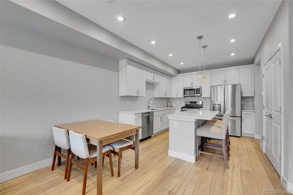 Dining room, Interior, Kitchen, Pendant Lights, Recessed Lighting, Stainless Steel Appliances, Wood Texture Flooring