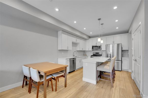 Dining room, Interior, Kitchen, Pendant Lights, Recessed Lighting, Stainless Steel Appliances, Wood Texture Flooring