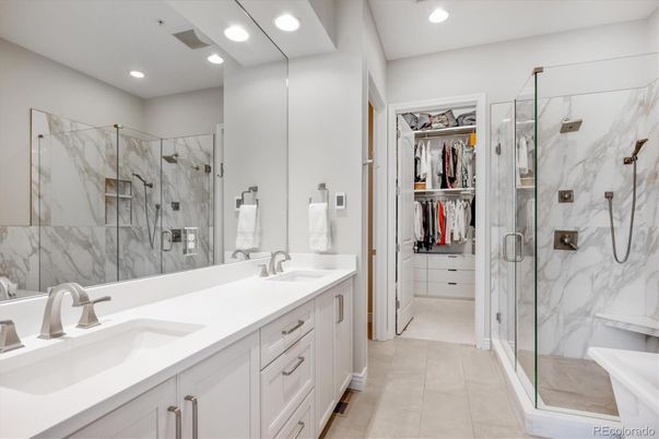 Bathroom, Dual Sink Vanities, Glass Shower, Interior, Marble Walls, Recessed Lighting, Walk-in Closets