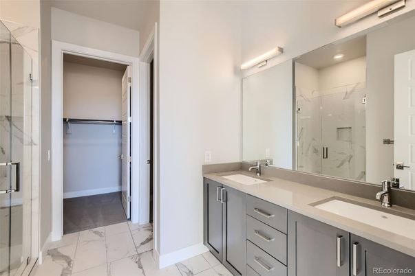 Bathroom, Dual Sink Vanities, Glass Shower, Interior, Marble, Marble Walls, Recessed Lighting, Walk-in Closets