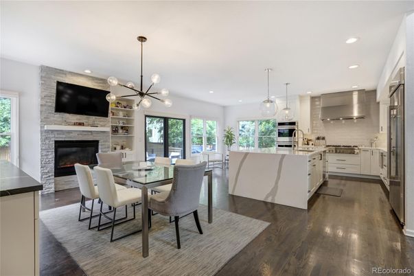 Dining room, Fireplace, Interior, Kitchen, Pendant Lights, Recessed Lighting, Stainless Steel Appliances, Stone Walls, Wood Texture Flooring
