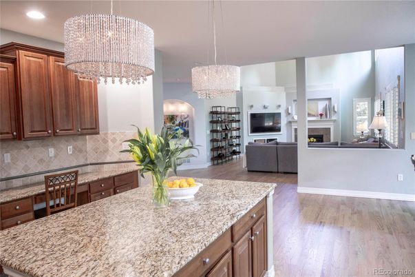 Chandelier, Fireplace, Interior, Kitchen, Living room, Pendant Lights, Recessed Lighting, Wood Texture Flooring