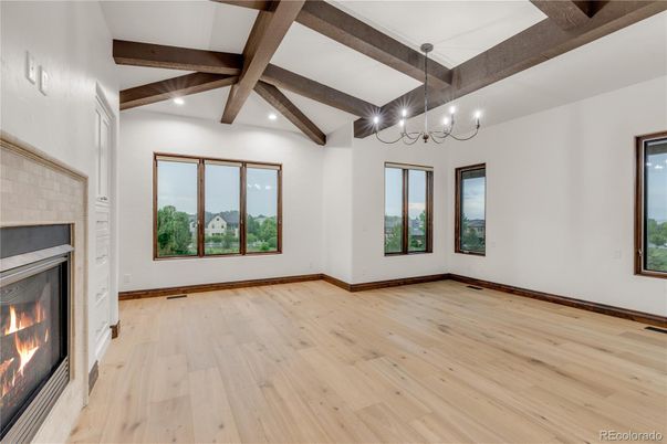 Chandelier, Empty room, Fireplace, Interior, Recessed Lighting, Wooden Beams, Wood Texture Flooring