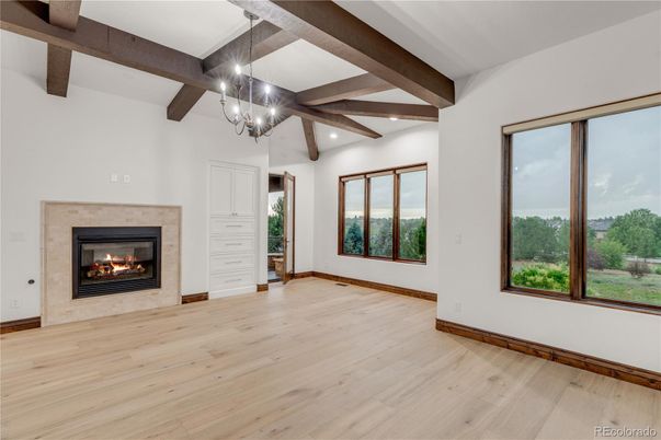 Chandelier, Empty room, Fireplace, Interior, Recessed Lighting, Wooden Beams, Wood Texture Flooring