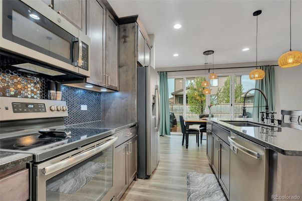 Dining room, Interior, Kitchen, Pendant Lights, Recessed Lighting, Stainless Steel Appliances, Wood Texture Flooring