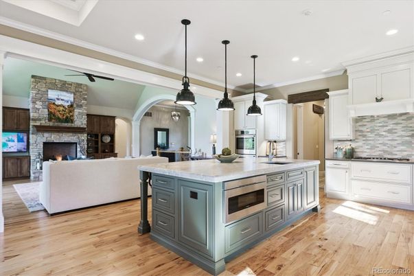Fireplace, Interior, Kitchen, Living room, Pendant Lights, Recessed Lighting, Stainless Steel Appliances, Stone Walls, Wood Texture Flooring
