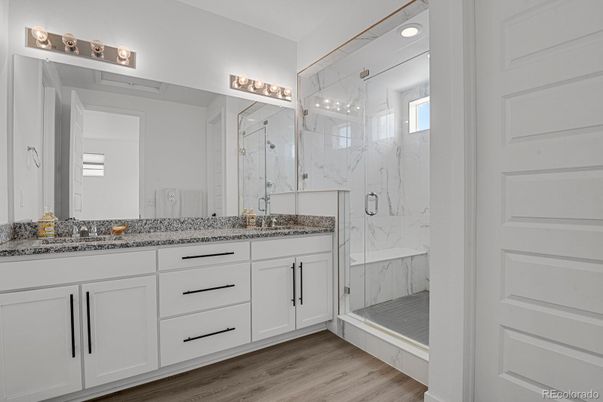 Bathroom, Dual Sink Vanities, Glass Shower, Interior, Marble Walls, Wood Texture Flooring