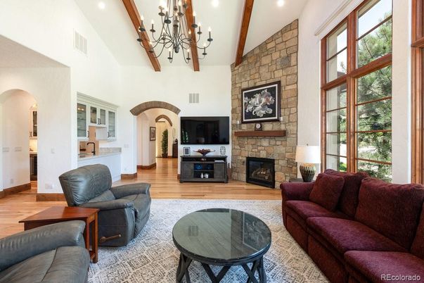 Chandelier, Fireplace, Interior, Living room, Recessed Lighting, Stone Walls, Wooden Beams, Wood Texture Flooring