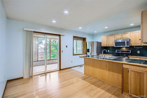 Interior, Kitchen, Recessed Lighting, Tile Countertops, Wood Texture Flooring