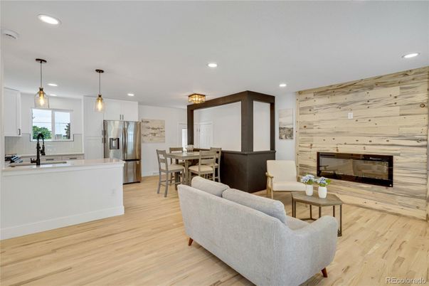 Dining room, Fireplace, Interior, Kitchen, Living room, Pendant Lights, Recessed Lighting, Stainless Steel Appliances, Wood Texture Flooring, Wooden Walls