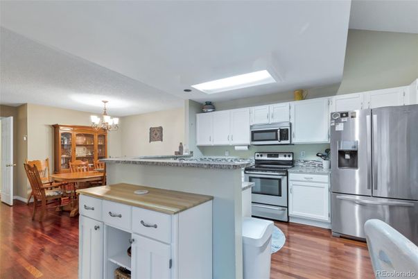 Chandelier, Dining room, Interior, Kitchen, Stainless Steel Appliances, Wood Texture Flooring
