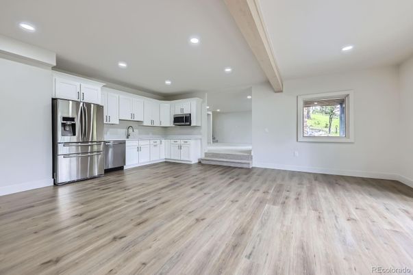 Empty room, Interior, Kitchen, Recessed Lighting, Stainless Steel Appliances, Wooden Beams, Wood Texture Flooring