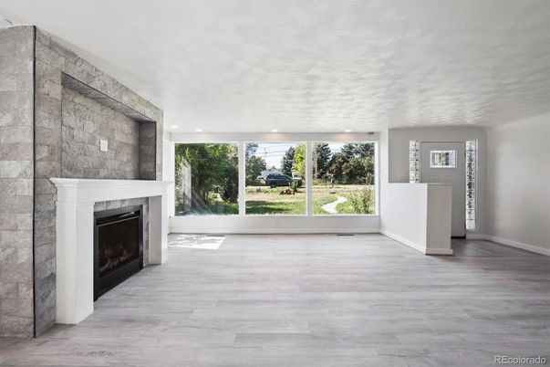 Empty room, Fireplace, Interior, Recessed Lighting, Stone Walls, Wood Texture Flooring