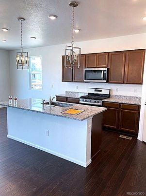 Chandelier, Interior, Kitchen, Pendant Lights, Recessed Lighting, Stainless Steel Appliances, Wood Texture Flooring